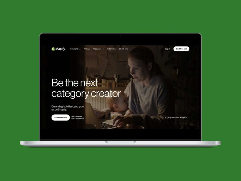 A screenshot of the Shopify hero section homepage on a laptop screen with a green background.