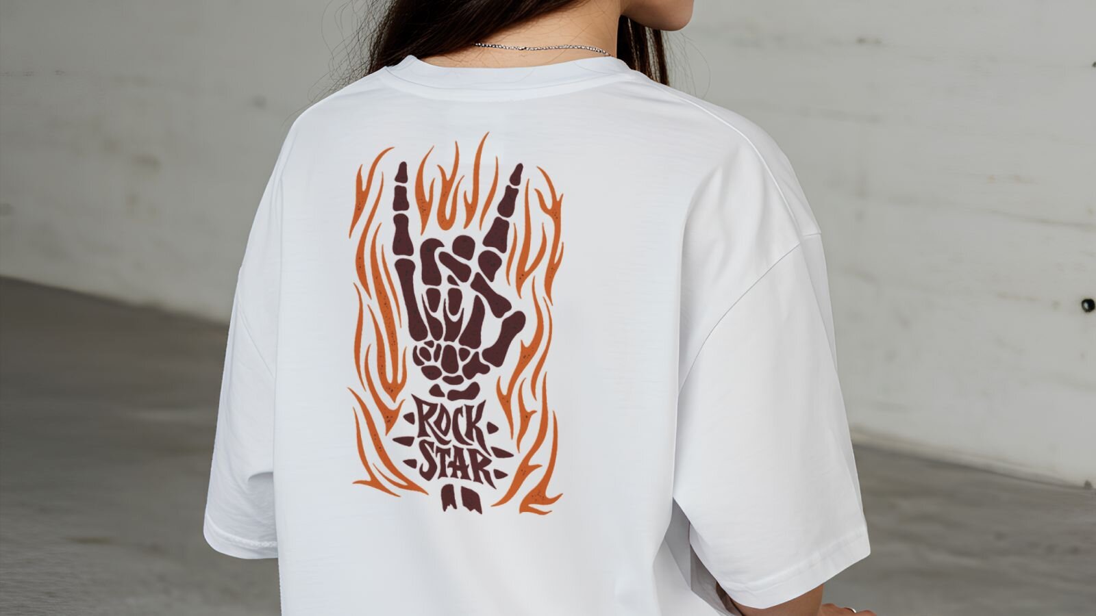 A close-up shot of a woman wearing a white “Rock star” t-shirt printed on the back.
