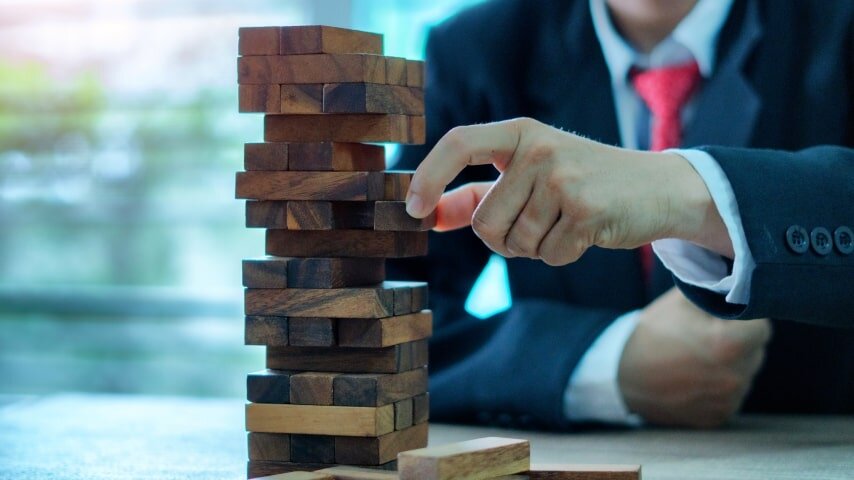 A person sitting and playing Jenga.