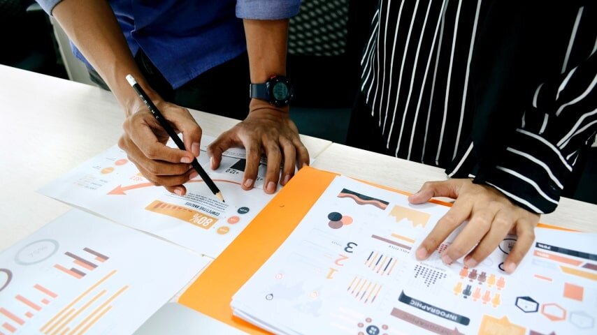 People working on some graphs and statistics.