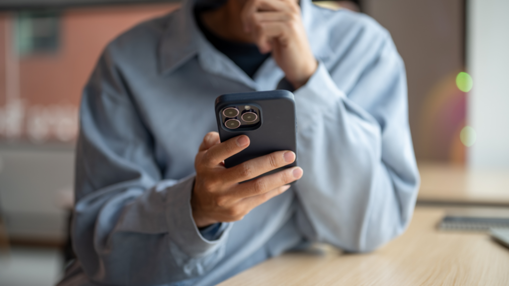A person is holding a smartphone in their hand.
