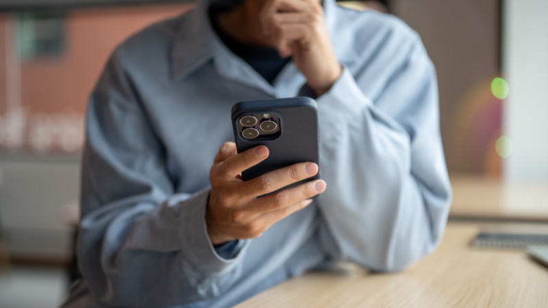 A person is holding a smartphone in their hand.