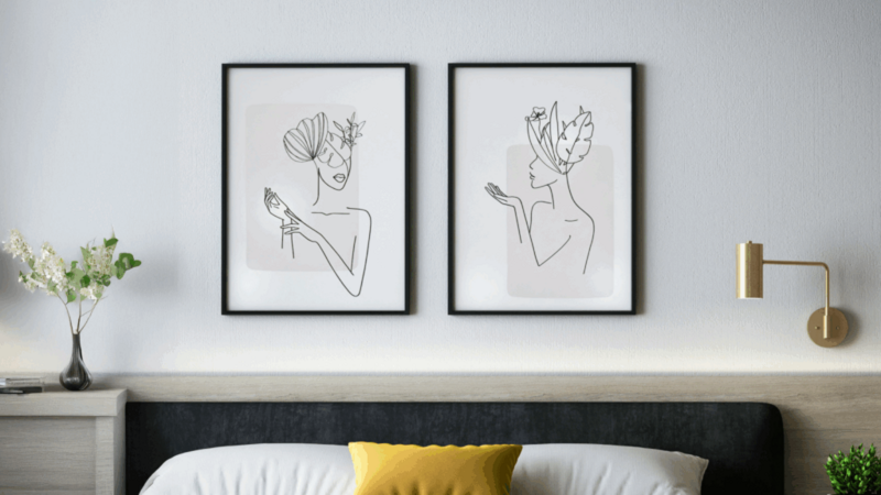 Modern bedroom featuring two framed artworks displayed on the wall, enhancing the contemporary decor.