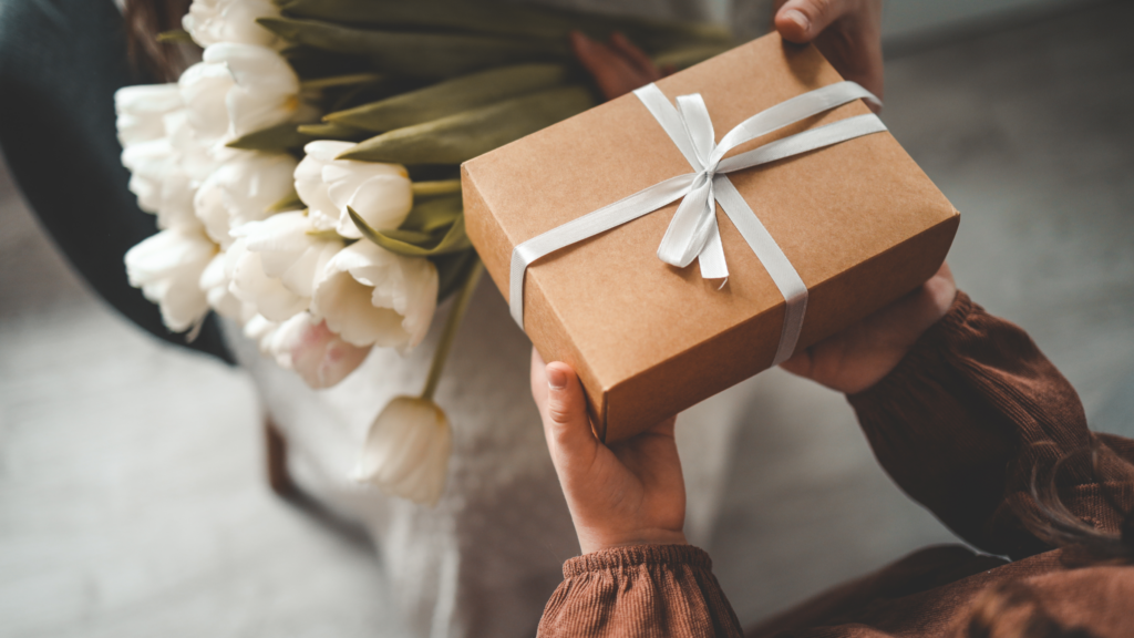 A heartwarming scene of a child presenting a beautifully wrapped surprise gift to a mother.