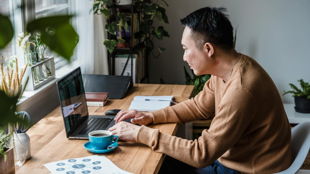 A person working from a home office using a laptop.