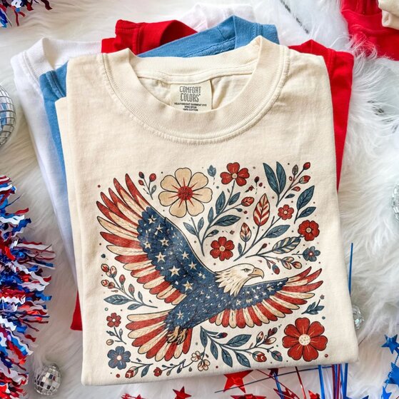 White 4th of July-themed t-shirt with fireworks colored as the USA flag.