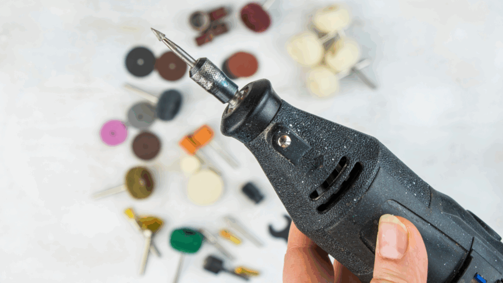 A person holding an engraving tool.