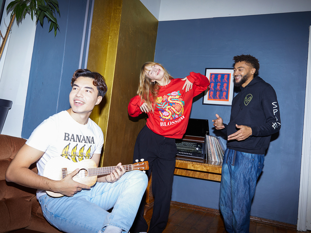 A group of people doing various activities while wearing custom print-on-demand apparel.