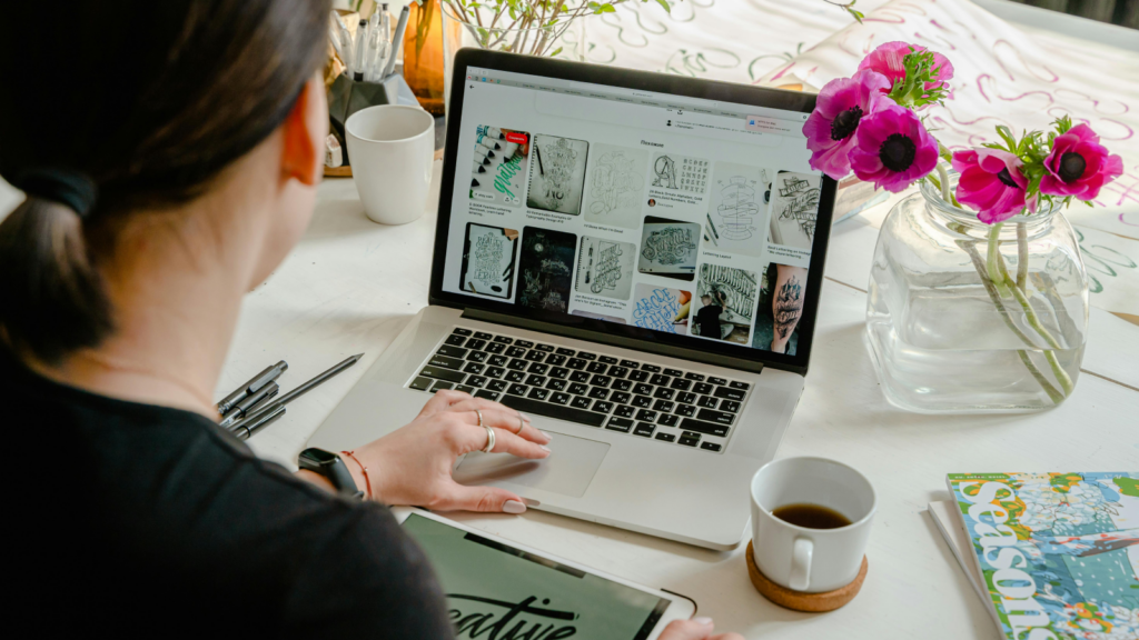 A woman sitting in front of a laptop, setting up a website for affiliate marketing.