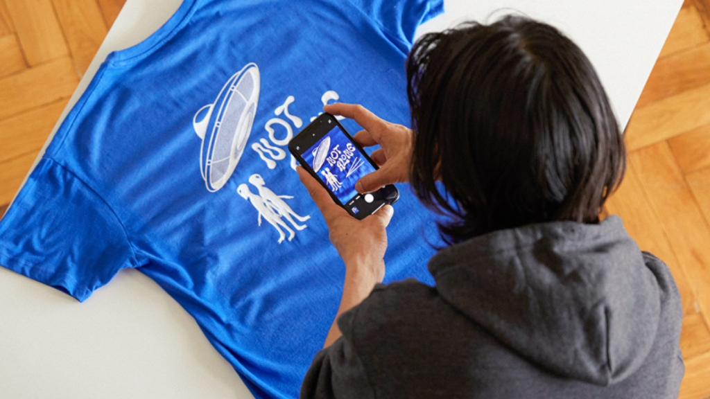 Custom “Not alone” alien-themed blue t-shirt.