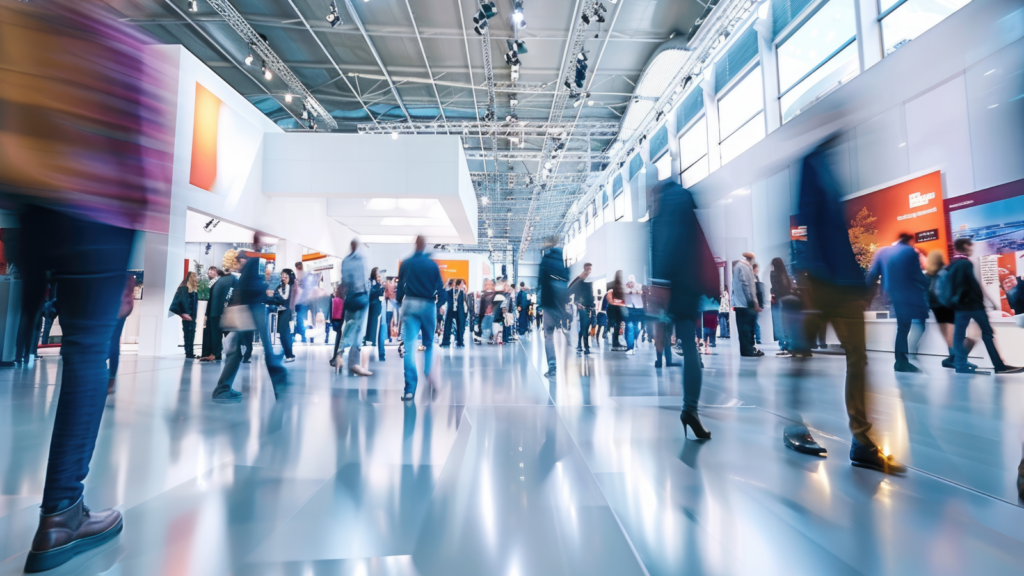 Blurred figures of people during a trade show.