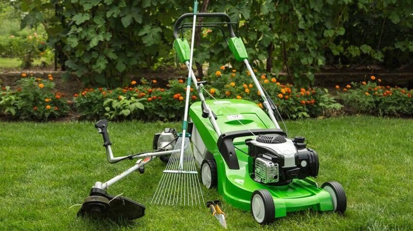 A lawn mower, weed wacker, rake, and garden shears.