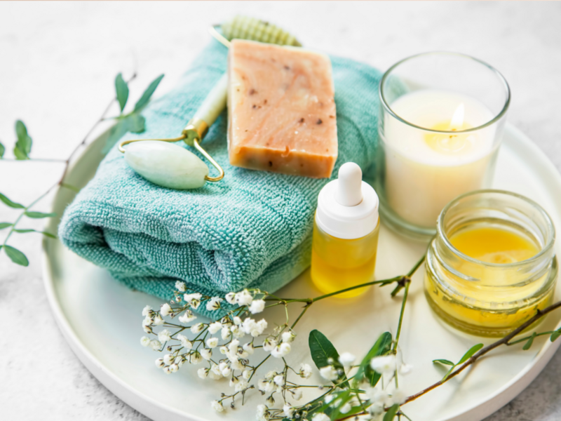 A stylish plate with a towel, soap, and candles, highlighting trendy best-selling items from Etsy for a perfect spa day.
