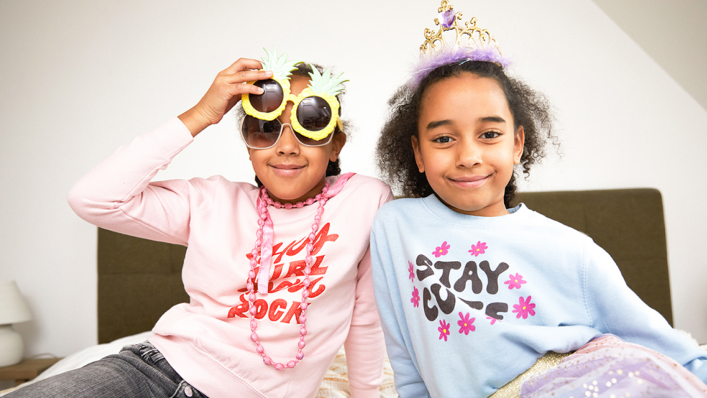 Two kids wearing custom sweatshirts as an example of what to sell on Shopify.