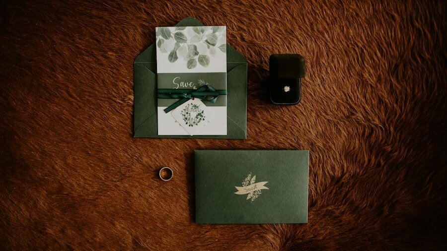 Wedding invitation with rings next to it.