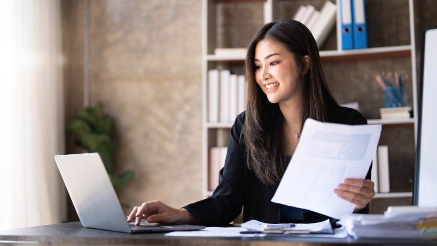 Woman working on taxes on her laptop.