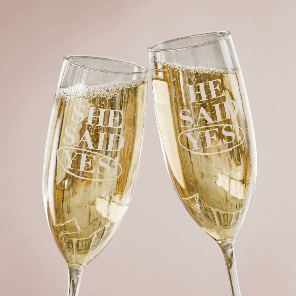 Two champagne flutes with engraved “He/She said yes” text.