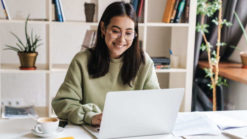 A woman is working on her laptop