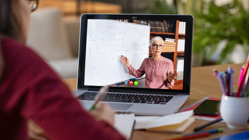A woman teaching online courses to a student.