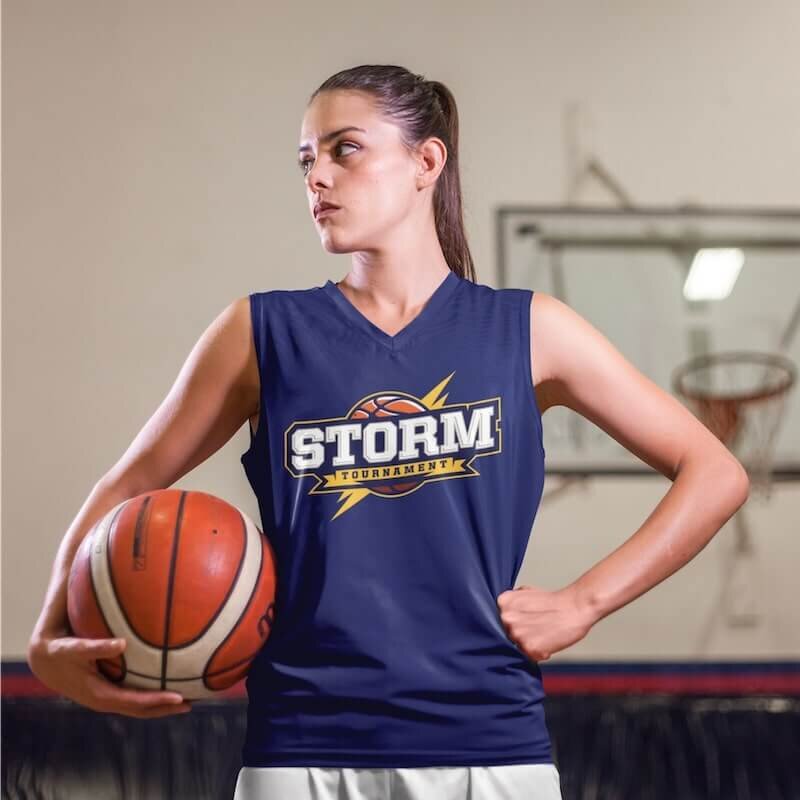 A woman basketball player wearing a purple jersey with a team logo print.