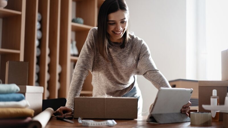 A woman packaging orders for her online store.