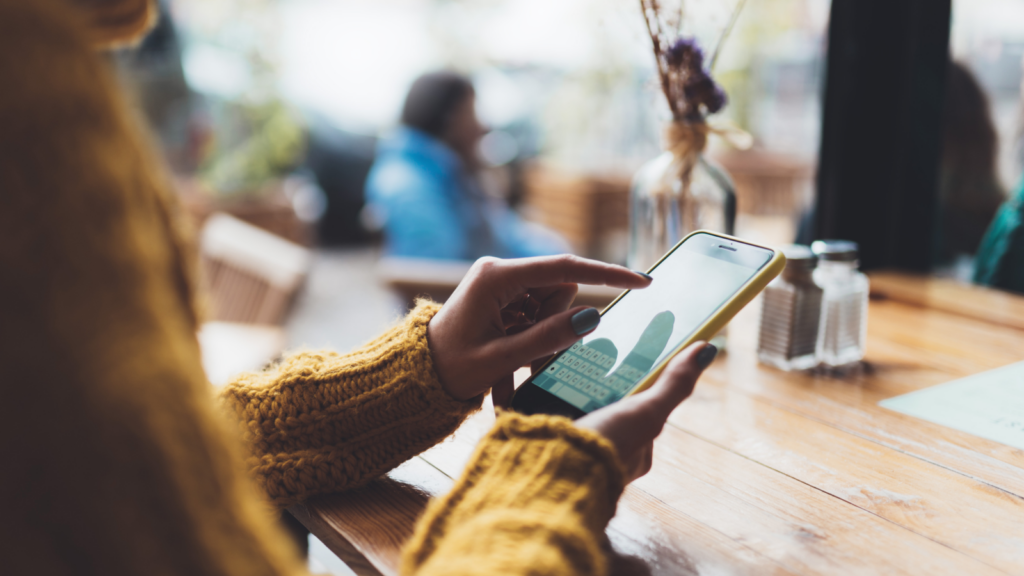 A person holding a phone, scrolling.