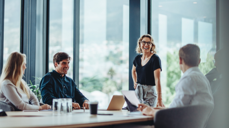 Several individuals collaborating and sharing ideas at a conference table, showcasing teamwork and communication.