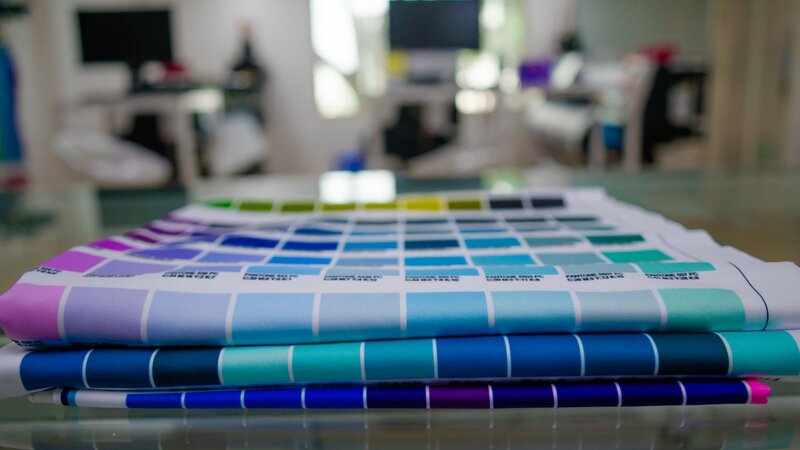 A person using a heat press to sublimate a garment.