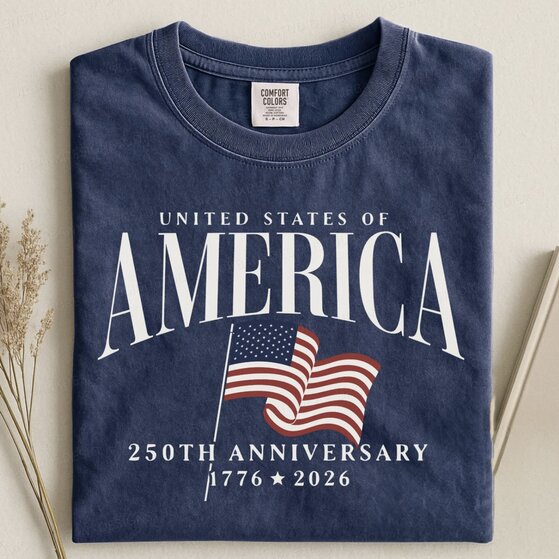 A woman wearing a beige 4th of July t-shirt that says 