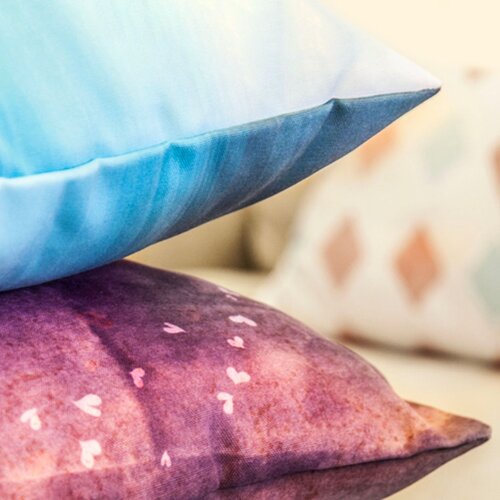 A custom cushion with “Tea and Messy Bed” text printed on.