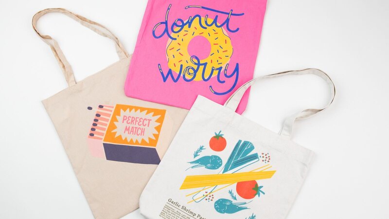 Three tote bags are displayed on a white background. All tote bags are in different colors and with different prints.