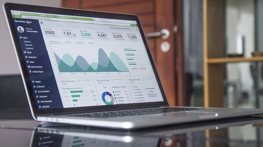 Laptop on the table with analytics on
