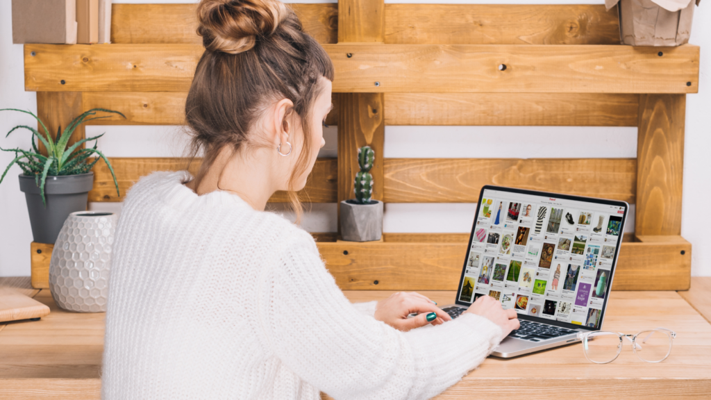 A woman sitting in front of a laptop and using Pinterest for affiliate marketing.
