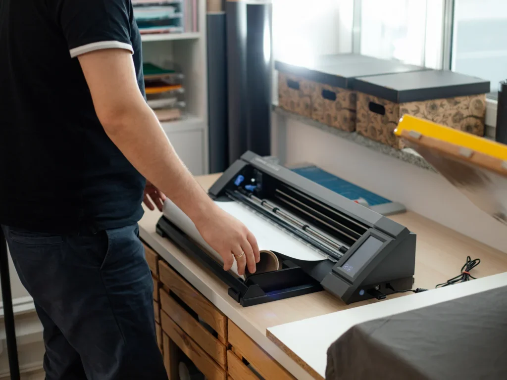 Person printing out their custom shirt design on heat transfer vinyl material.