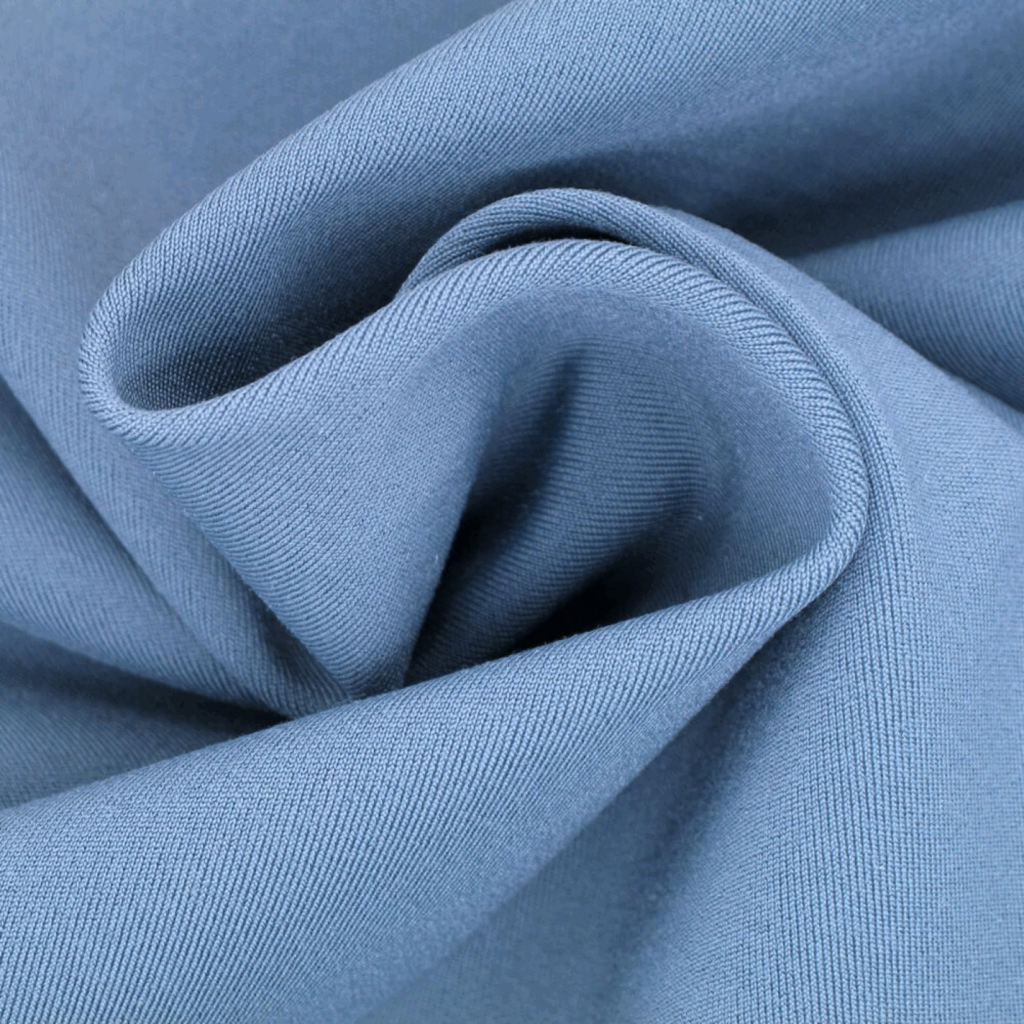 Close-up of light blue spandex with a visible weave pattern, twisted into a spiral shape.