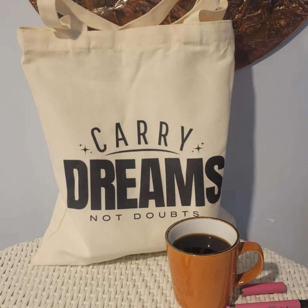 A tote bag with the text “Carry dreams, not doubts.”