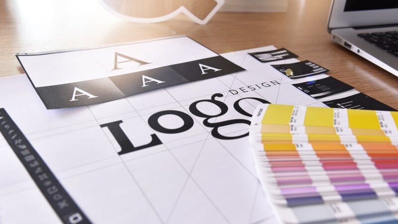 A collection of font and color samples for a company logo.