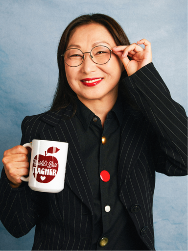 Teacher holding a World's Best Teacher mug