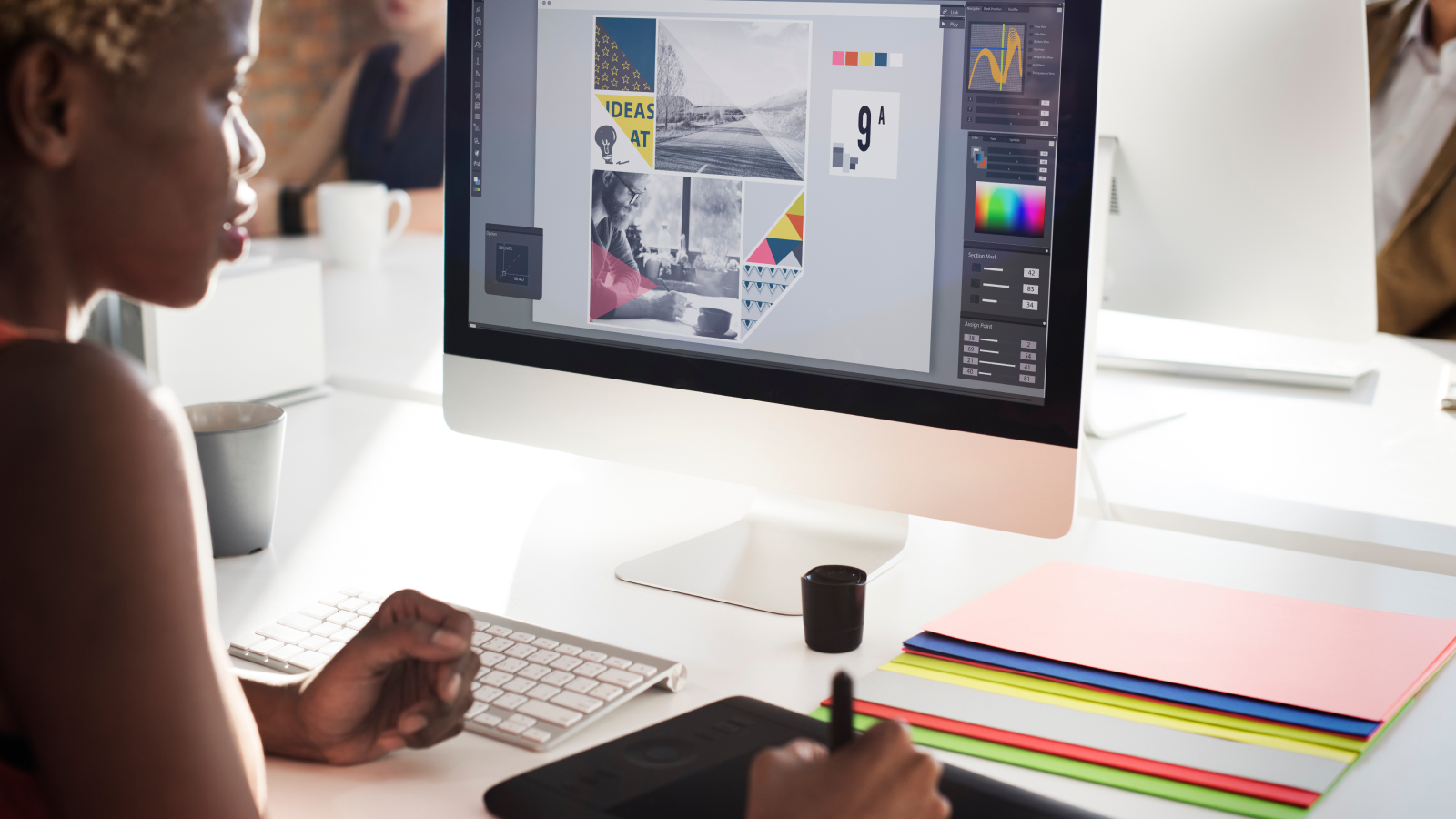 Designer creating an ad layout on a computer.