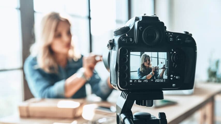 A woman filming a video tutorial.