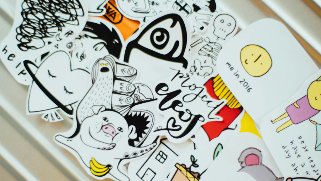 An assortment of stickers on a white wall, highlighting diverse patterns and vibrant colors.