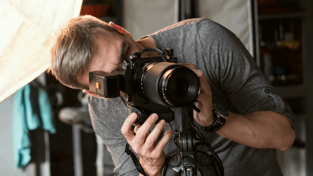 A photographer is taking a picture using a DSLR camera.
