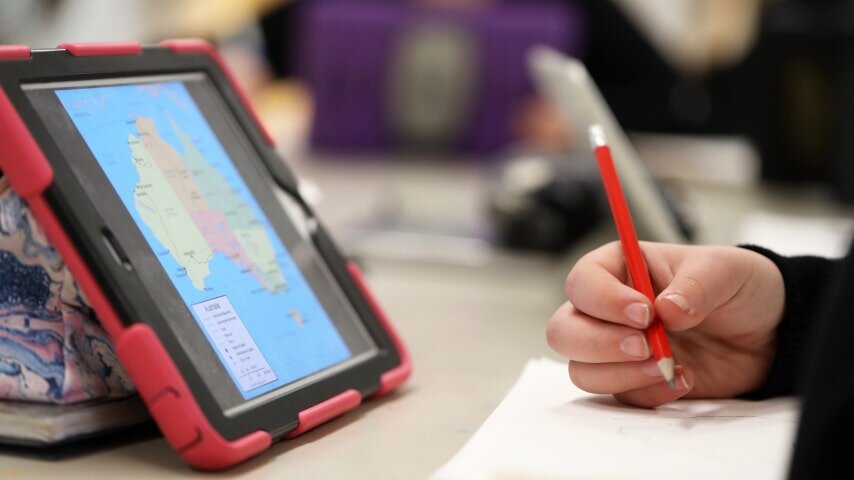 Person looking at a map of Australia on their tablet screen while doing market research.
