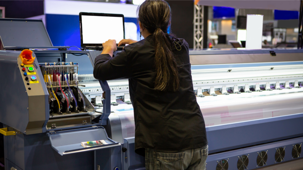 A person working a sublimation printer.