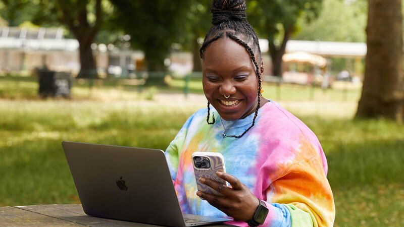 A person is holding a mobile phone with the TikTok app loading screen.