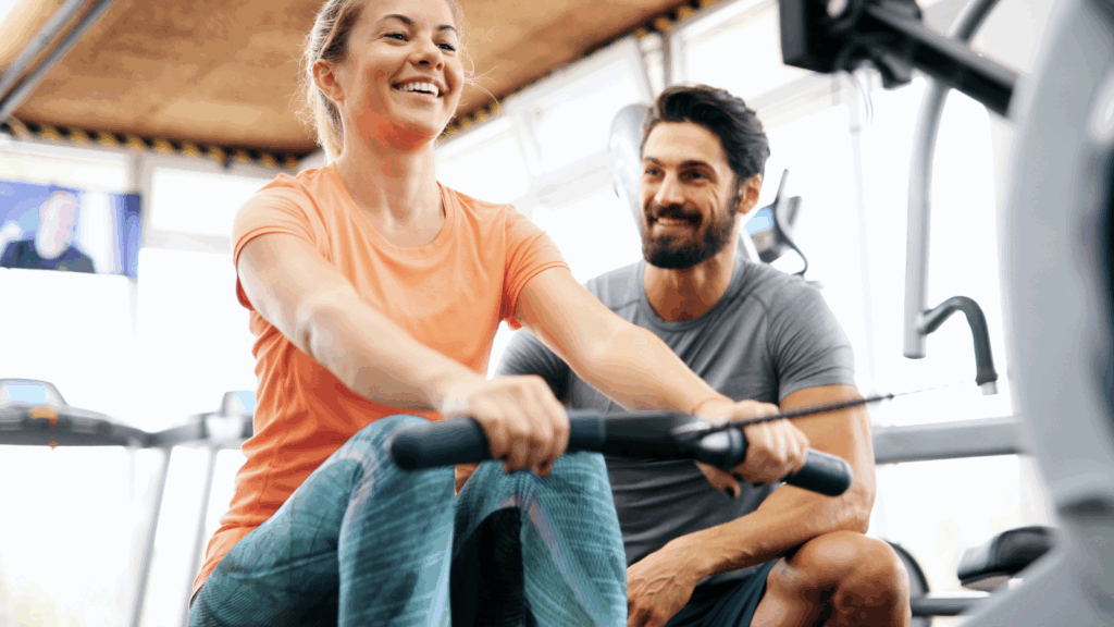 A woman and a personal trainer (a man) are working out.