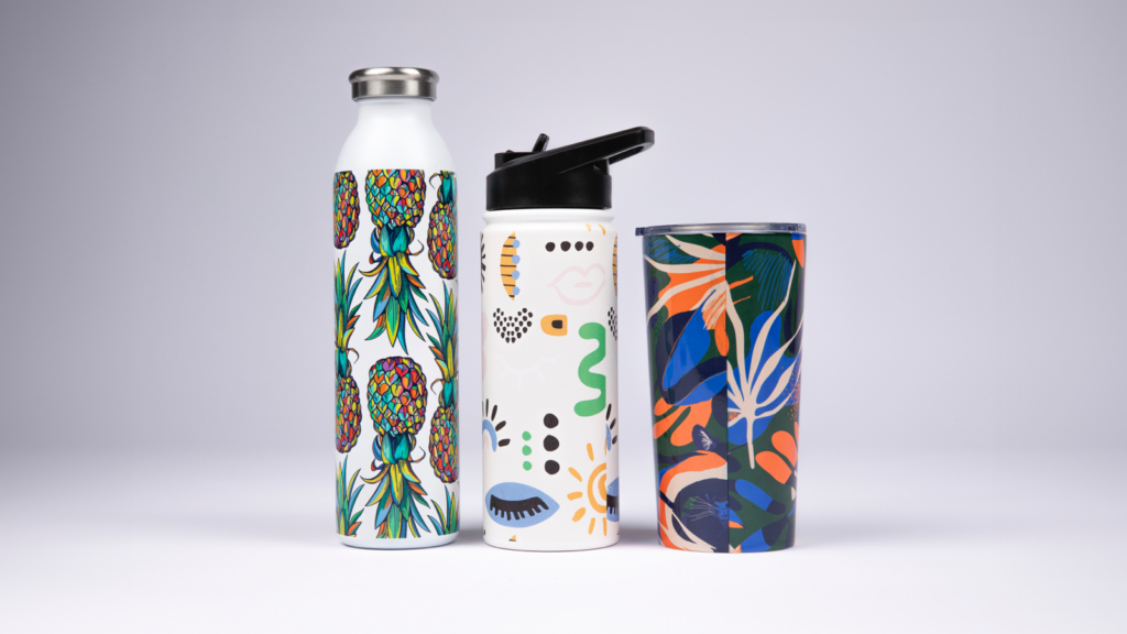 Three reusable water bottles with custom prints used as promotional products.