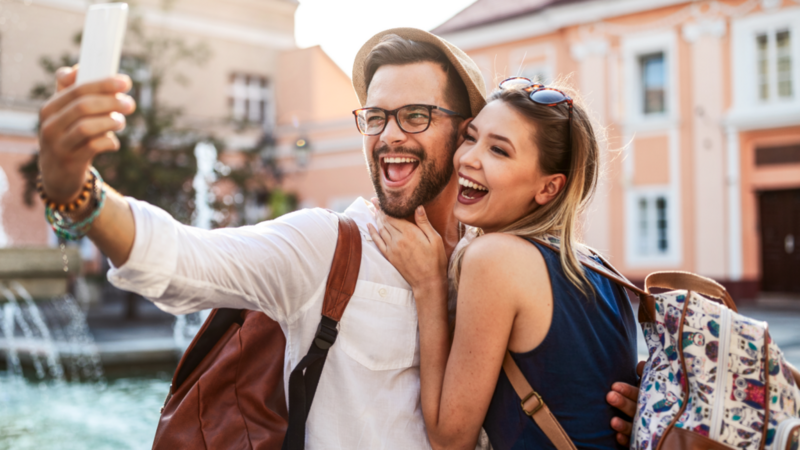 A couple (man and woman) is taking a selfie during a trip.
