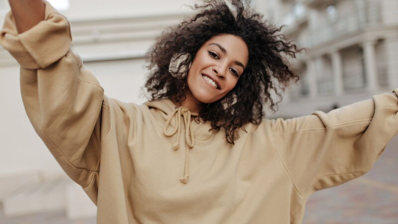 A woman dancing in a hoodie