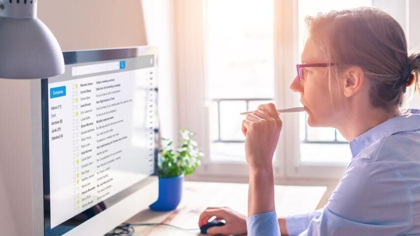 A woman using email marketing as a marketing channel to drive traffic to a Shopify store.